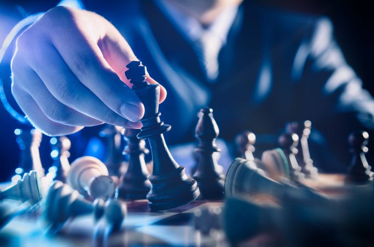 Photo ID: B04. Chess financial business strategy concept. Team leader holding chess piece.