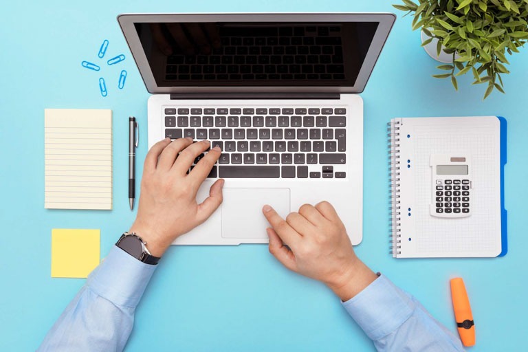 Photo ID: B16. Workspace with laptop, office supplies. Man working on stylish table desk