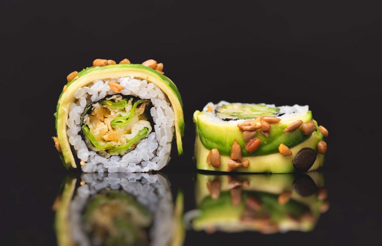 Photo ID: C05. Sushi roll set on black glass background. Japanese Asian traditional food front view