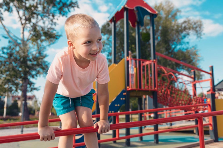 Photo ID: L02. Happy little boy on children playground. Childhood and leisure concept