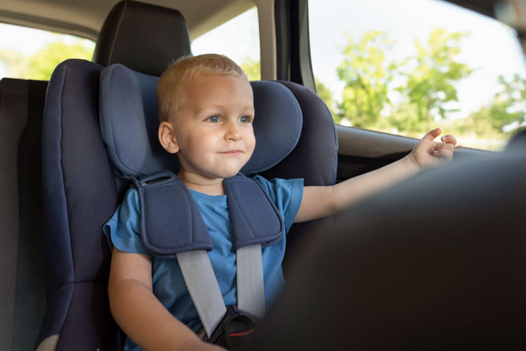 Photo ID: L03. Boy buckled into car seat. Safe family travel concept