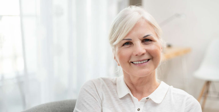 Photo ID: L12. Happy senior woman in living room. Looks beautiful in retirement