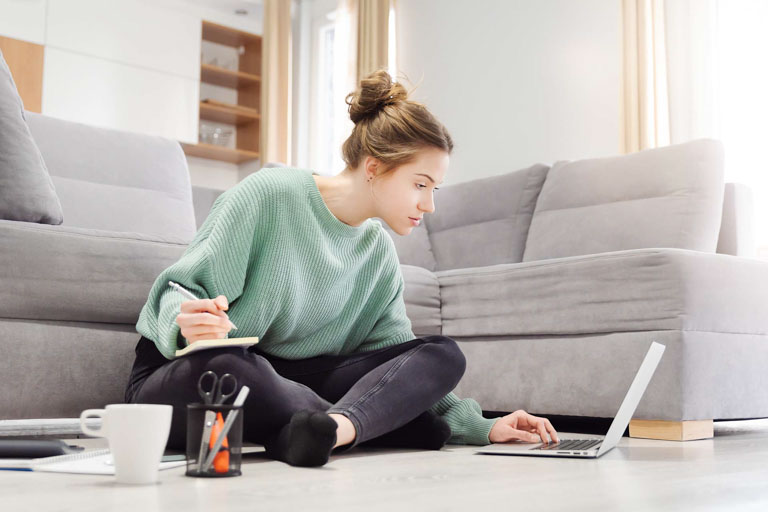 Photo ID: L15. Young student learns at home on the floor. Studying, learning concept. Image with copy space.