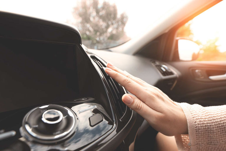 Photo ID: T06. Air conditioning in the car. Cold air.. Driver hand tuning air ventilation grille